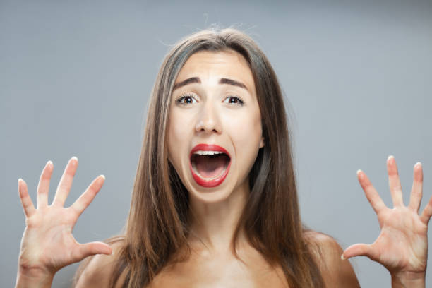 istock Beautiful brunette girl studio portrait. Screaming and surprised expression. 1362840002