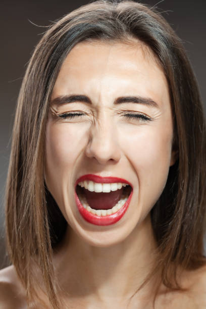 istock Beautiful brunette girl studio portrait. Screaming and surprised expression. 1362840107