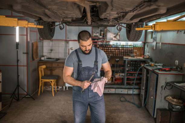 istock Car mechanic who wipes his tool and prepares it for use 1362842689