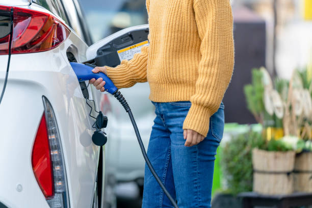 istock Close up plugging in electric car charger 1362844484