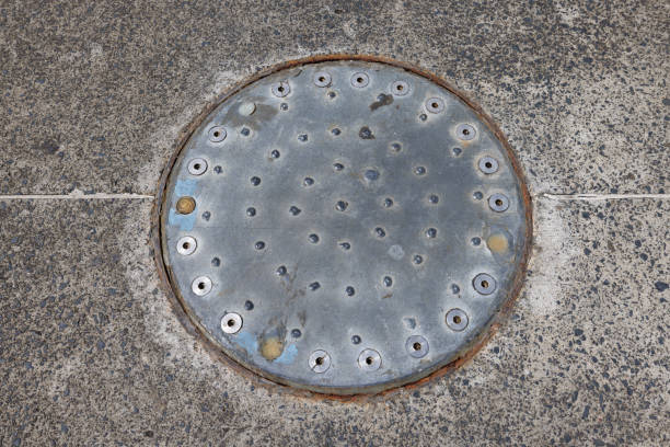 Closed sewer lid or manhole cover isolated on white.