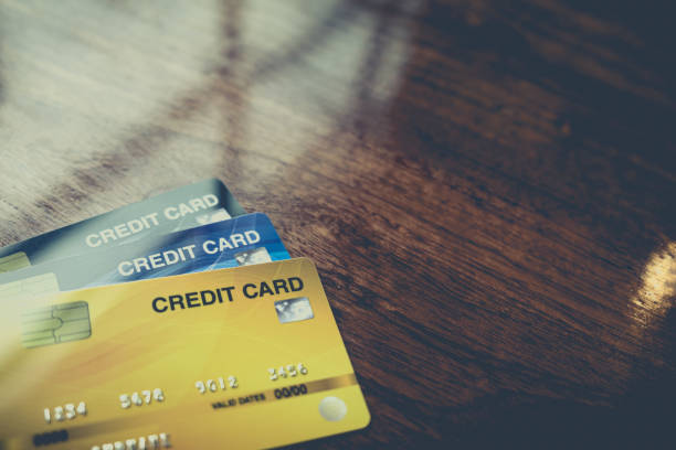 Credit card. Close up credit card on the wooden table for making debit payment and shopping on banking with selective focus for background. Copy space credit card paying banking business stock pictures, royalty-free photos & images