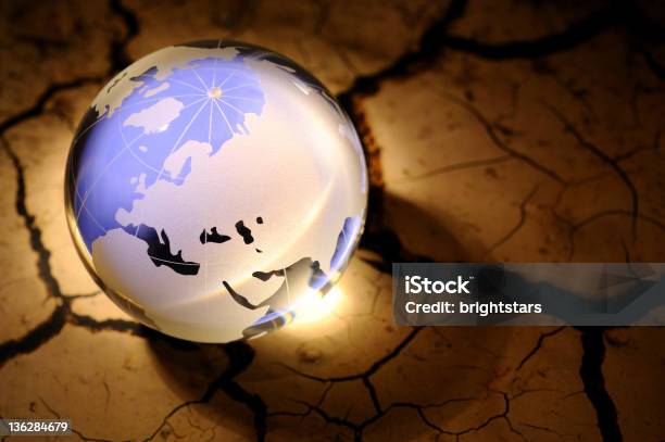Blue Globe On Cracked Dirt Stock Photo - Download Image Now - Arid Climate, Back Lit, Barren