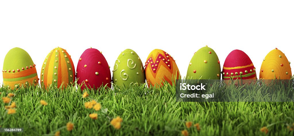 Colorful easter eggs Colorful easter eggs in a row on green grass Easter Stock Photo