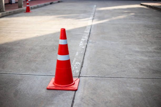 istock Orange traffic cones on cement road surface. 1362849572