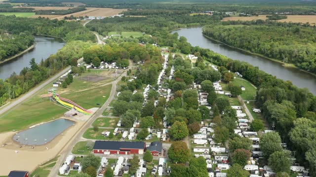 Flying high above the camping in Sainte-Genevieve-de-Batiscan showing the rv in the campground near the river