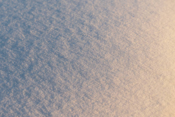 a view of the snow texture at a high angle with a gradient from warm sunlight to cold shadows
