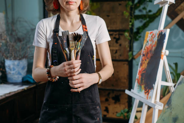 istock Woman artist creating canvas with paint in studio 1362858357