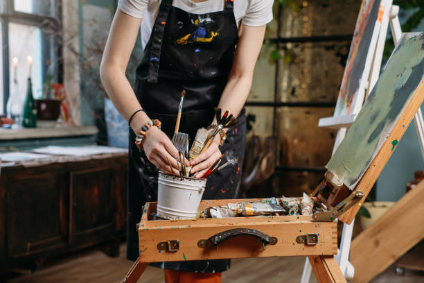 istock Woman artist creating canvas with paint in studio 1362859082