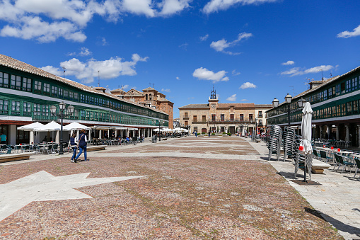 Almagro, Spain - April 24, 2016: Main Square of Almagro with tourists strolling through the wooden arcades, Almagro, Spain