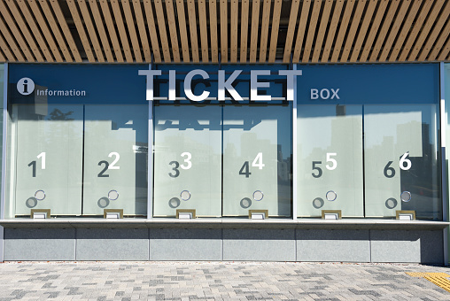 Close-up of closed ticket office with sunlight.