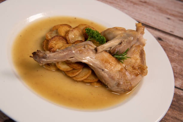 istock Rabbit casserole recipe with olives and herbs, sauteed potatoes 1362861926