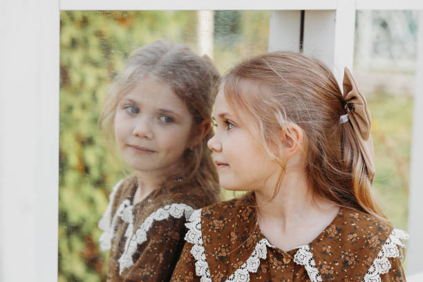 istock Beautiful girl looks at her reflection on a walk 1362864723