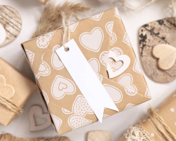 istock Valentines present with blank gift tag and hearts close up, Rustic label Mockup 1362866615