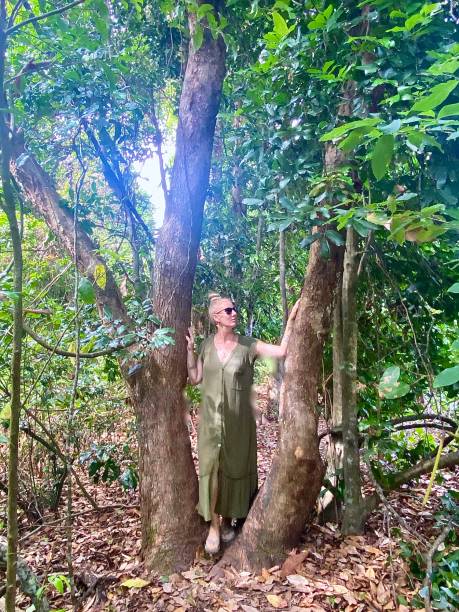 istock Woman Stands on Forest Tree Trunk 1362869223