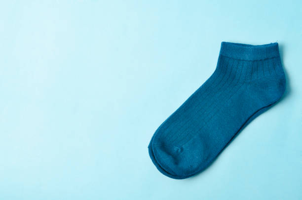 istock Blue socks on blue background and space for text. 1362869500