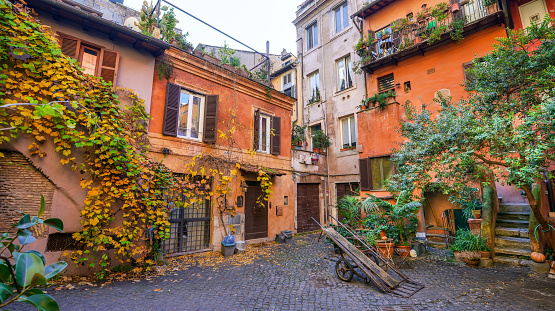 A picturesque and hidden alley near Campo de Fiori square, in the historic and baroque heart of Rome. The Campo de Fiori district is an area of the Eternal City much loved and visited by tourists and young people for the presence of ancient churches and noble palaces and for the countless artistic and cultural treasures of the Renaissance and Baroque era. But Campo de Fiori is also famous for its characteristic flower and fruit and vegetable market that occupies the square every morning, for the numerous trendy restaurants and pubs and for the characteristic alleys to be discovered while walking freely, where you can experience the essence and the soul of Roman life. In 1980 the historic center of Rome was declared a World Heritage Site by Unesco. Super wide angle and high definition image in 16:9 format.