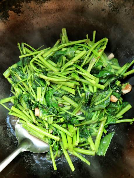 istock Cooking Stir fried Morning Glory vegetable in cooking pan. 1362870736