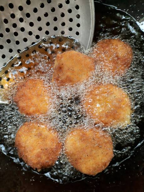 istock Frying Shrimp Cakes using colander - food preparation. 1362871827