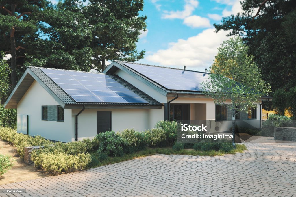 Energy Efficient House With Solar Panels And Wall Battery For Energy Storage Modern single storey house with solar panels and wall battery for energy storage. House Stock Photo