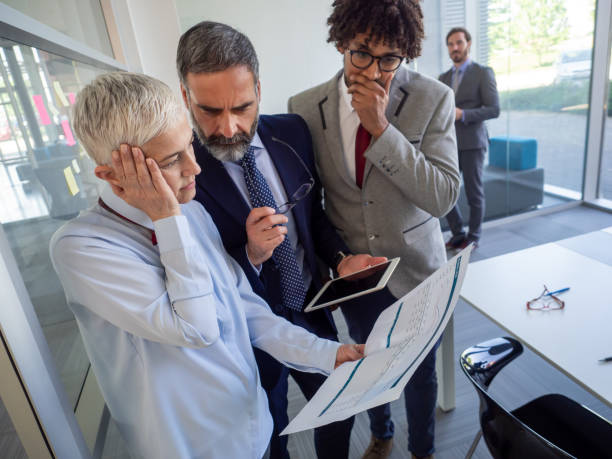 istock Business, teamwork, people and crisis concept. Business people solving problem in office 1362873157