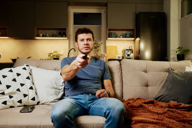 istock man use remote control to watch tv 1362873161