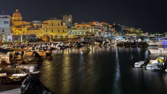 Night view of Forio marina with boats moored at the pretty fishing port, Ischia, Italy