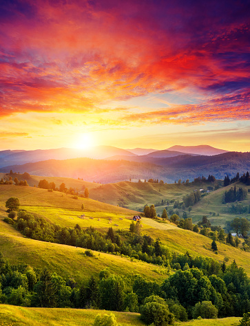 Beautiful green hills glowing by sunlight at twilight. Dramatic scene. Colorful sky. Carpathian, Ukraine, Europe. Beauty world.