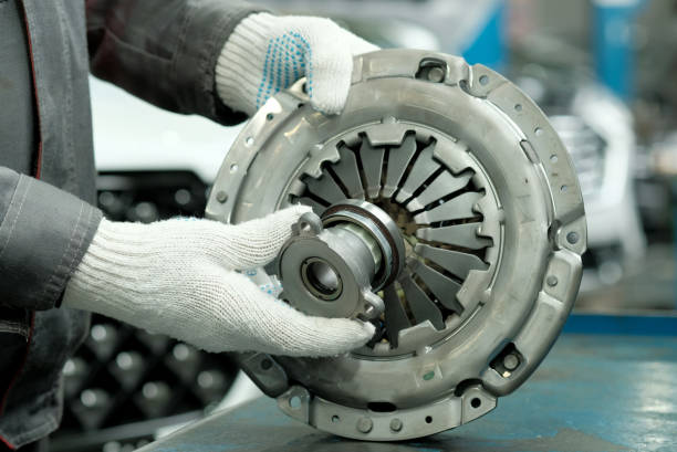 Auto parts. Clutch kit close-up. An auto mechanic checks the technical condition of the drive disc, the driven disc and the exhaust bearing. Repair and maintenance in a car service. coupling stock pictures, royalty-free photos & images