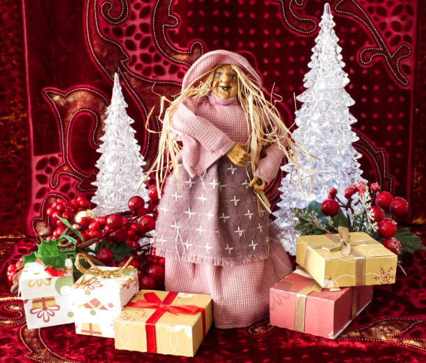 The Befana with yellow straw hair on Christmas background. Traditional witch costume for Italian Epiphany day. stock photo