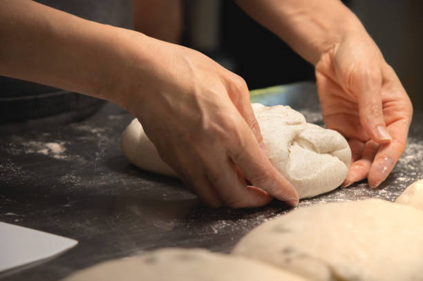 istock Close-up baker making bread, female hands, kneading dough, cooking 1362879623