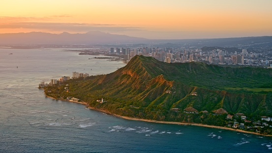 Aerial view of Diamond head mountain with city in background at sunset, Honolulu, Hawaii Islands, Oahu, USA.