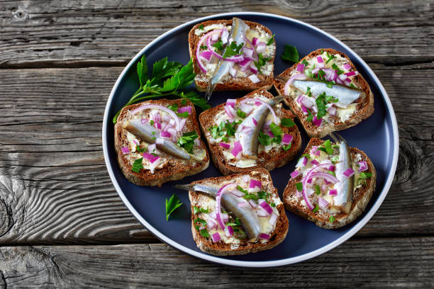istock pickled sprat rye bread open sandwiches, top view 1362880839