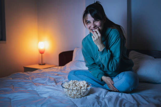 istock Woman having fun watching TV late at night 1362883474