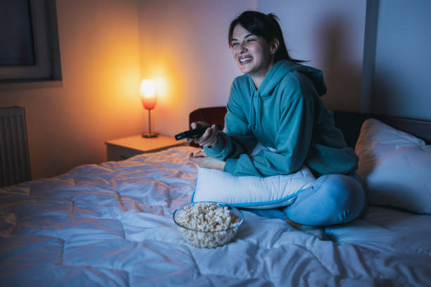 istock Woman having fun watching TV 1362883494