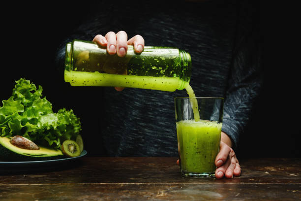 istock Woman making detox smoothie at home. 1362883554