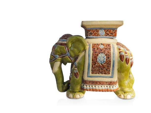 istock side view antique green and cream elephant ceramic standing on white background, vintage, object, animal, decor, copy space 1362885047