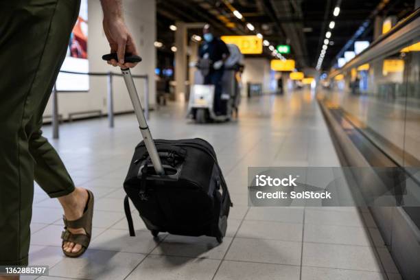 Travelling Light Stock Photo - Download Image Now - Amsterdam Schiphol Airport, Airport, Wheeled Luggage