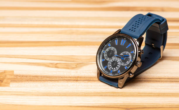 istock Watch, beautiful modern wristwatch positioned on a rustic wooden surface, selective focus. 1362887563