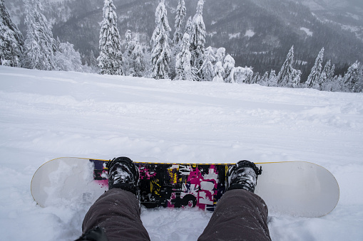 snowboarder at the hill enjoying mountains landscape point of view