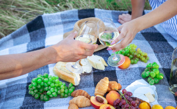 istock couple in love drinks wine at a picnic. Selective focus 1362890564