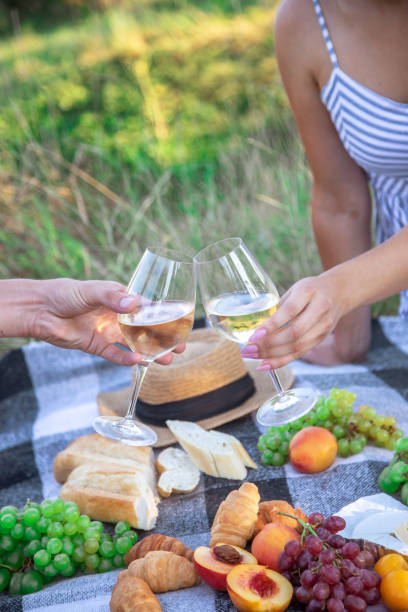 istock couple in love drinks wine at a picnic. Selective focus 1362890567