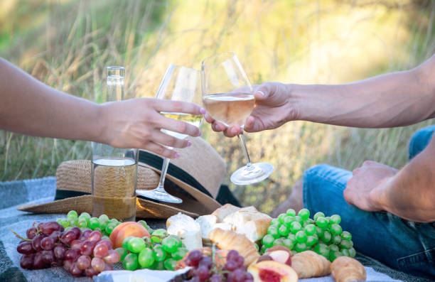 istock couple in love drinks wine at a picnic. Selective focus 1362890568