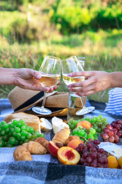 istock couple in love drinks wine at a picnic. Selective focus 1362890585