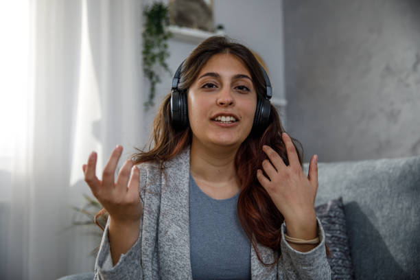 istock Young woman on a video call gesturing while talking, looking at camera 1362891991