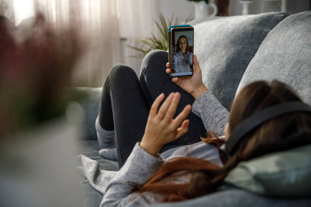istock Waving to a friend via video call while talking 1362892004