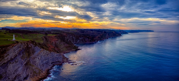 The lighthouse of Lastres  at sunset located in the town of Luces, Asturias, Spain.