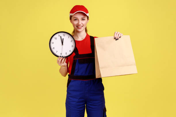 istock Courier woman holding parcel and wall clock, fast delivery service, delivering in time. 1362893078