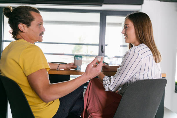 istock Two business colleagues sitting at table, chatting during coffee break 1362893203