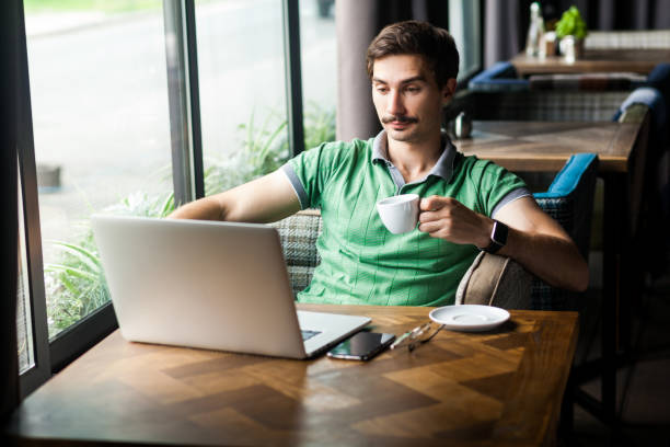 istock Businessman enjoying hot coffee while working online on laptop, having break during work. 1362893786